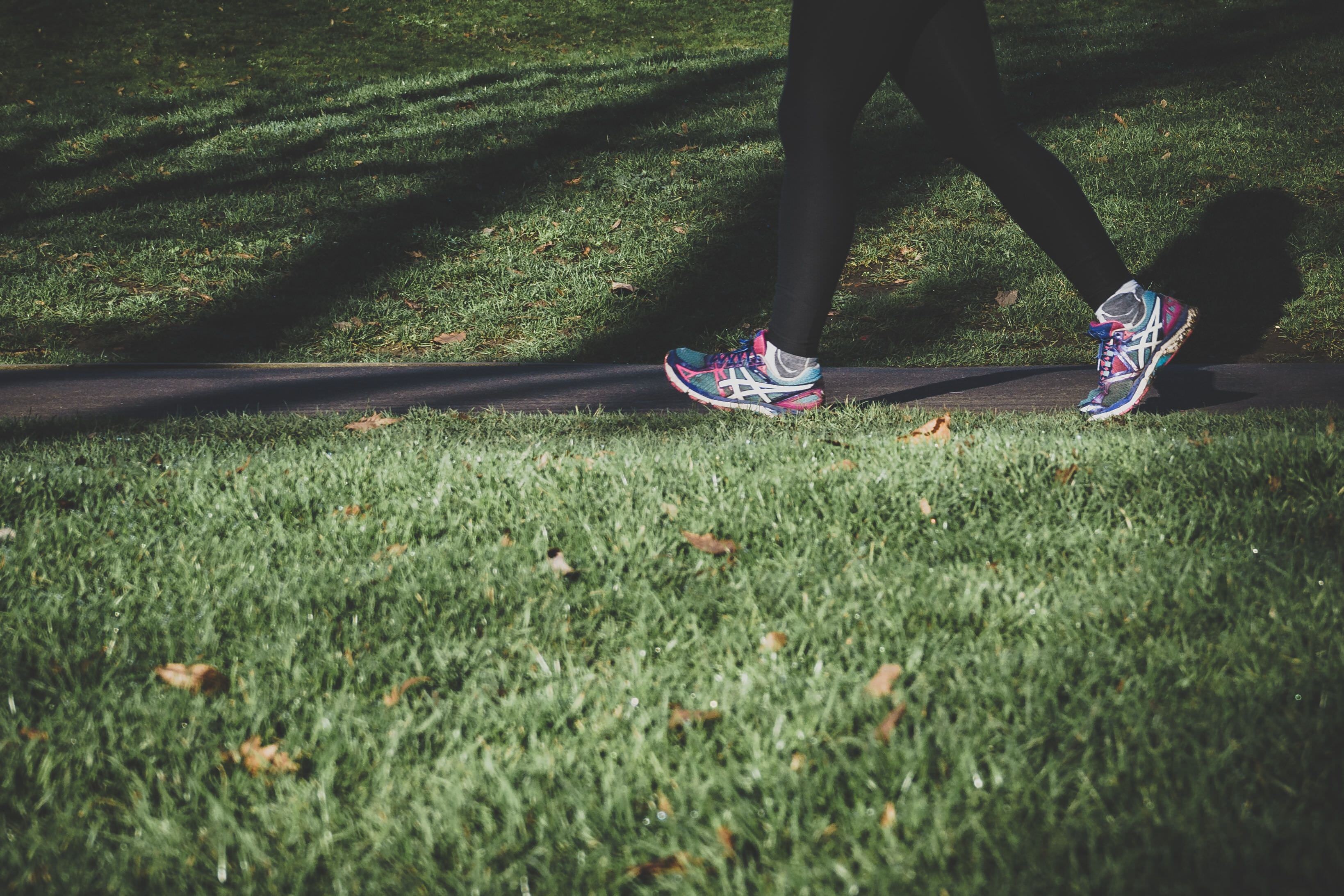 Close up on a person's feet while running in a park.