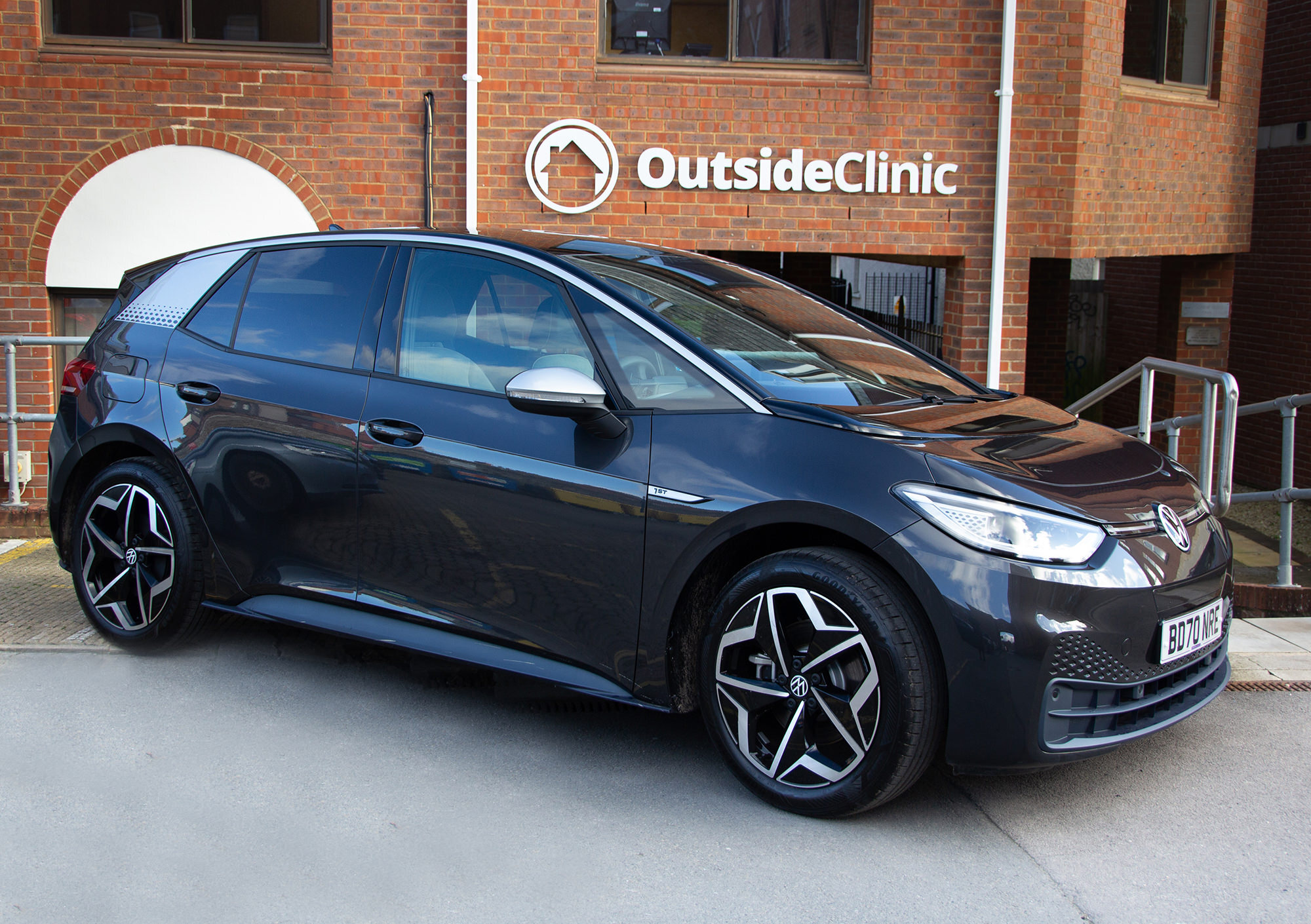 A black car in front of the old OutsideClinic office.