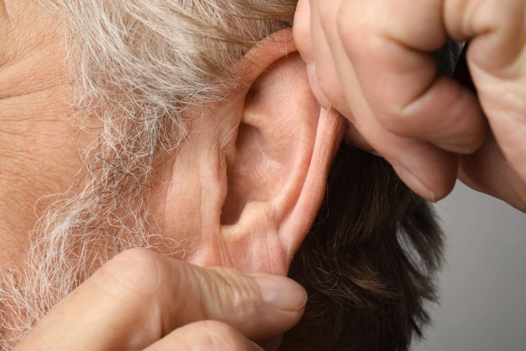 A close up photo of an elderly gentleman's ear